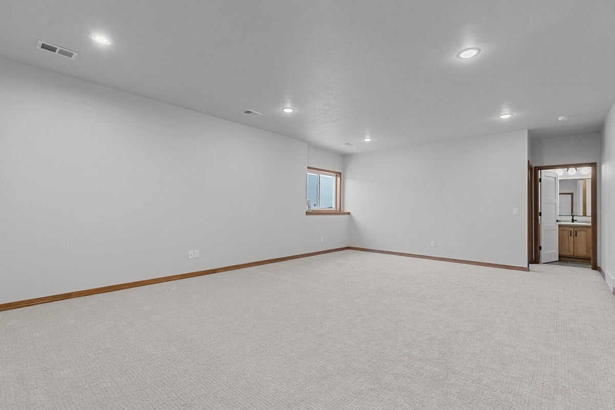 Finished basement with carpet flooring in Midwest Design Homes project in Wisconsin