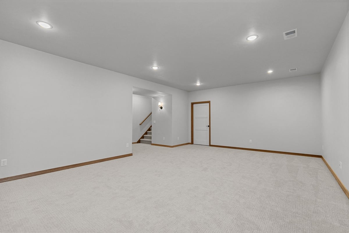 Finished basement with soft carpeting in custom home by Midwest Design Homes in WI