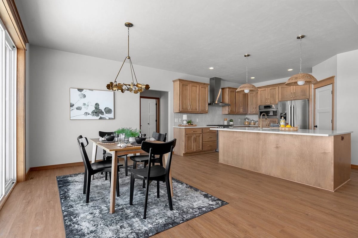 Kitchen and dining room with pendant lighting in Kaukauna, WI custom home by Midwest Design Homes