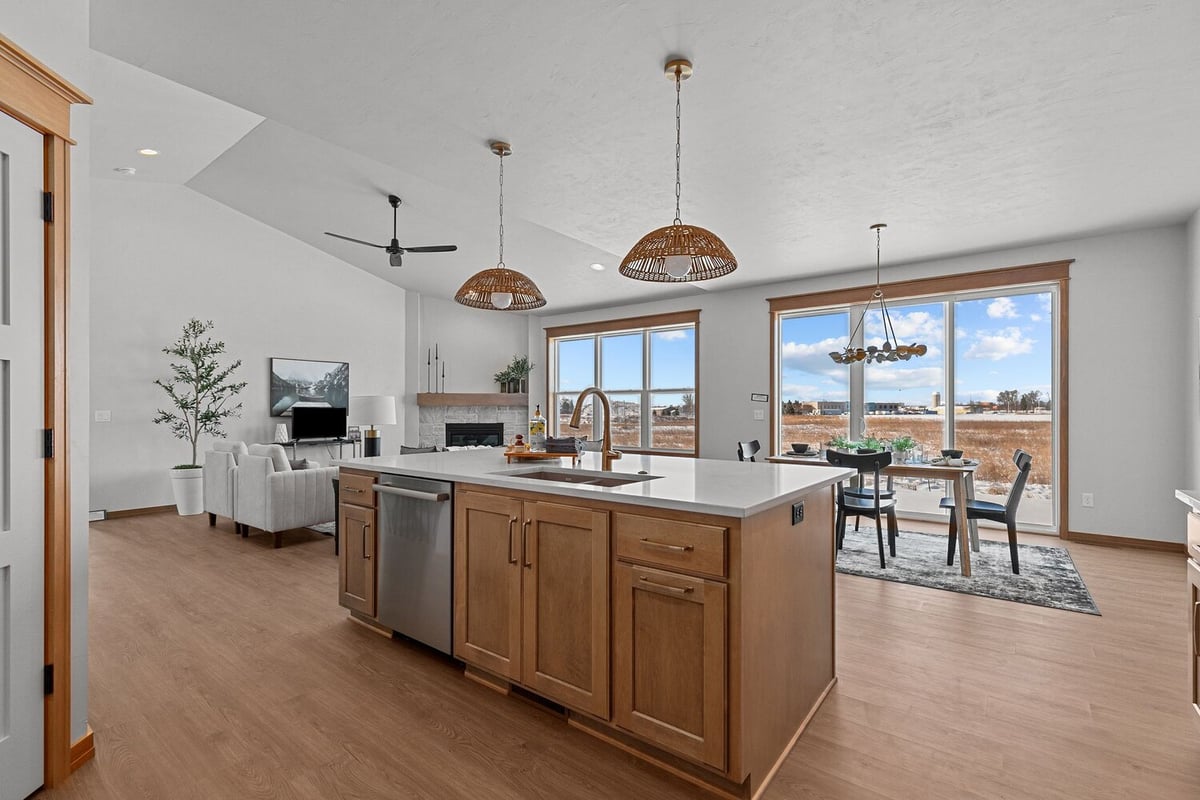 Kitchen island and dining space in open layout by Midwest Design Homes in Kaukauna, WI