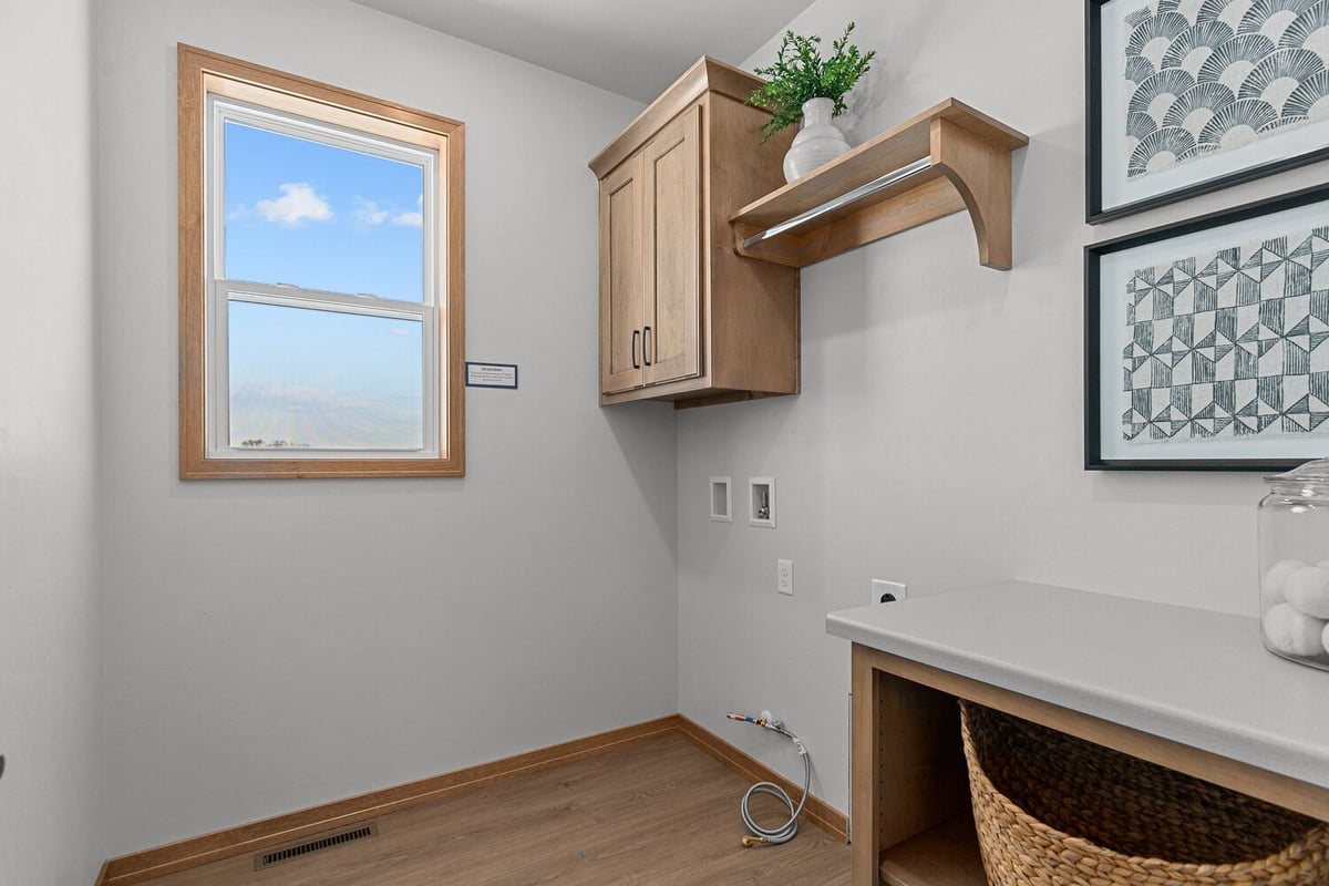 Laundry room with storage cabinets by Midwest Design Homes in Appleton WI