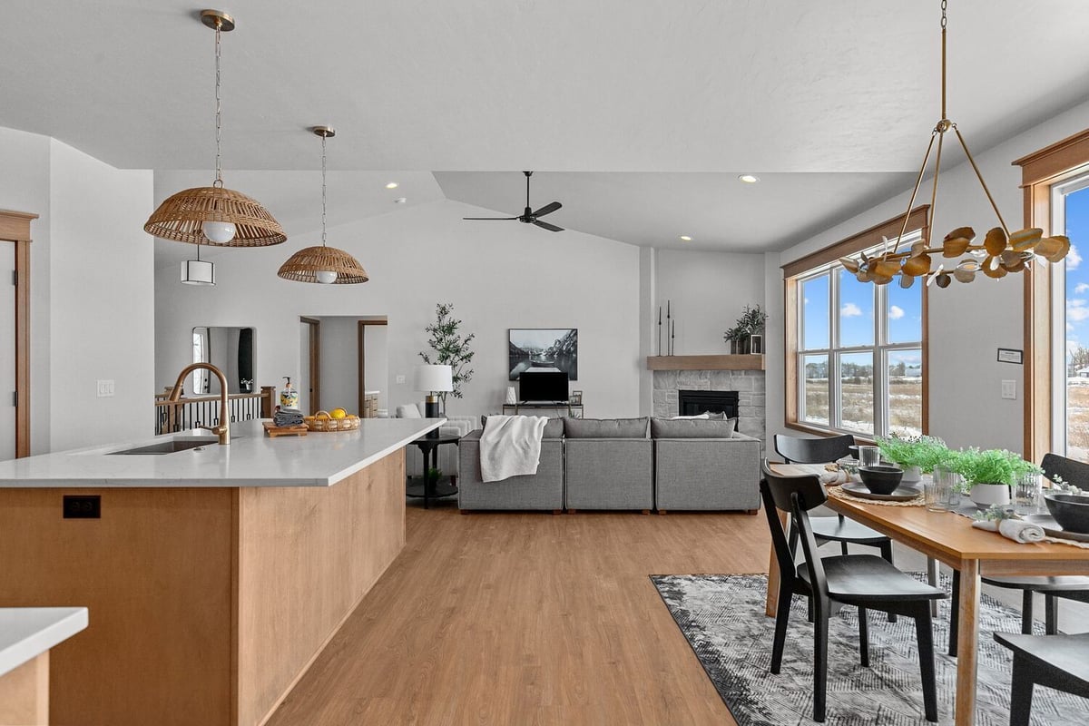 Open living area with fireplace and kitchen in custom home by Midwest Design Homes in WI
