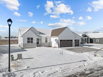 Side angle of snowy custom home exterior by Midwest Design Homes in Kaukauna, WI