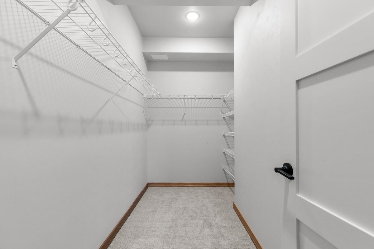 Walk-in closet with wire shelving in custom Fremont WI home by Midwest Design Homes