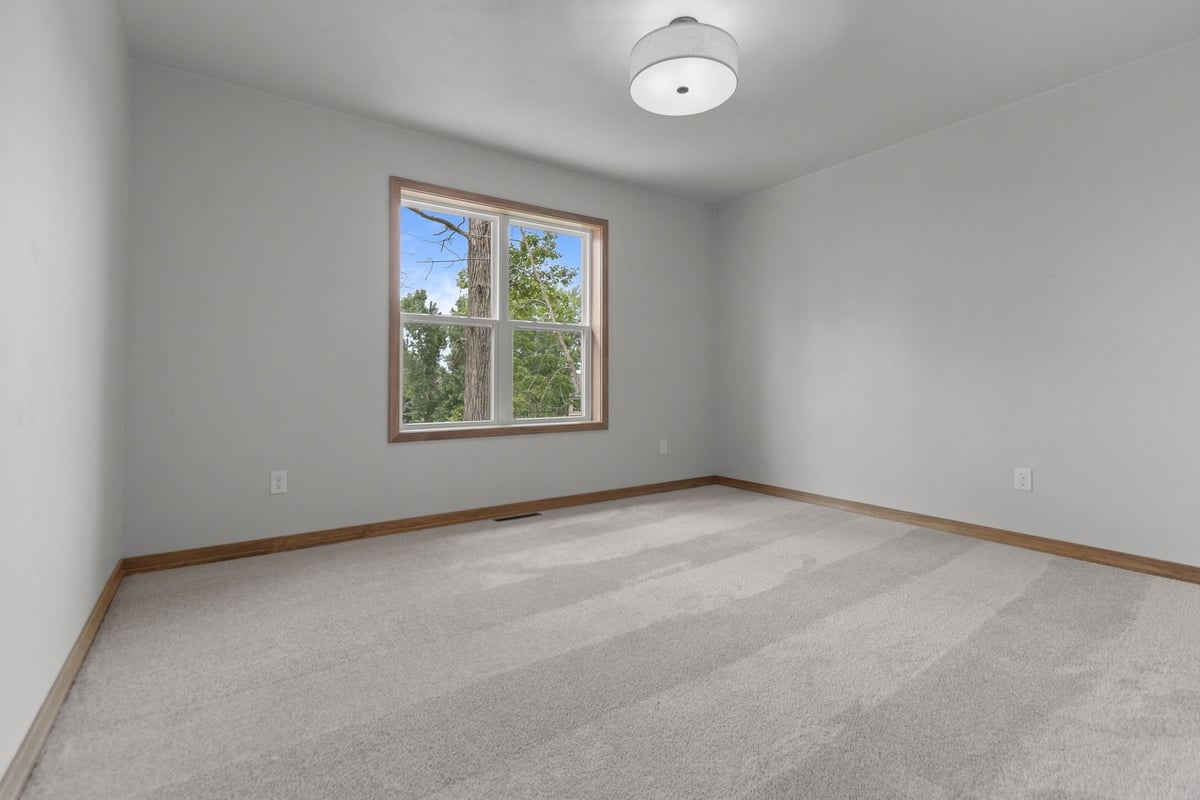 Bright carpeted bedroom by Midwest Design Homes in Neenah WI and De Pere WI