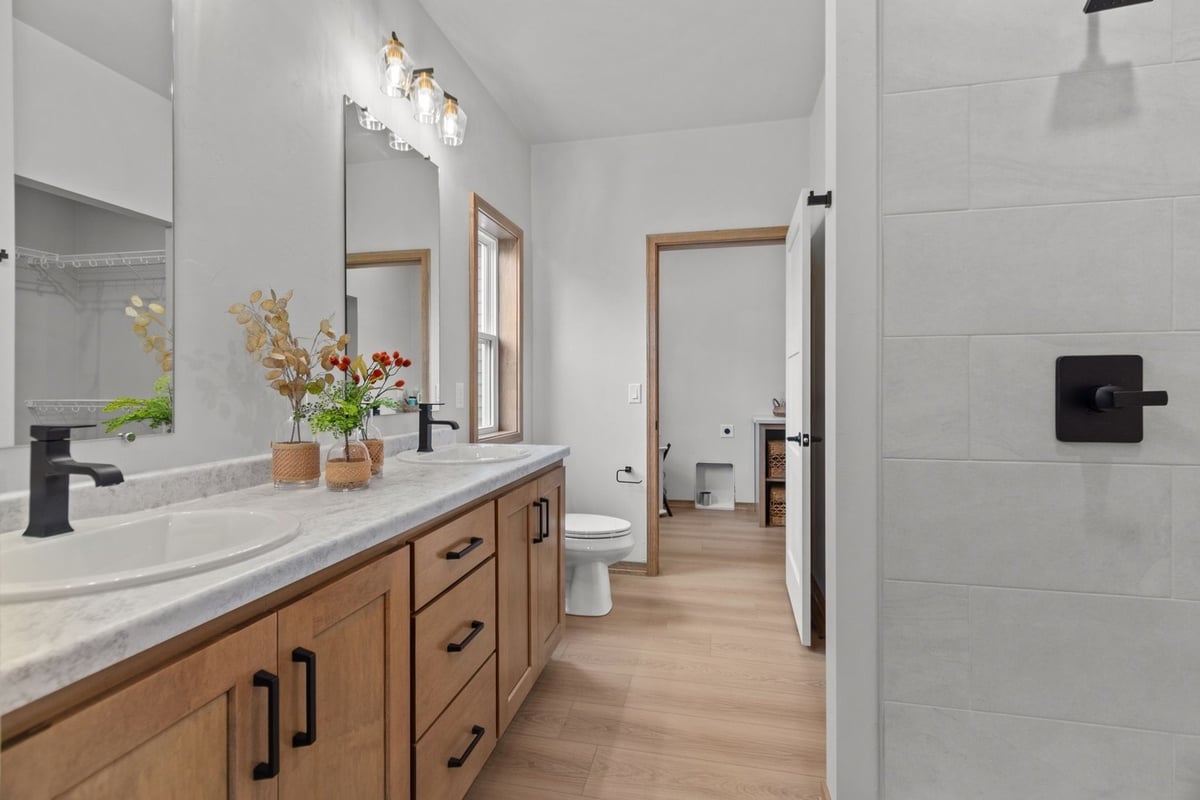 Dual-sink vanity in custom bathroom by Midwest Design Homes in Kaukauna, Wisconsin