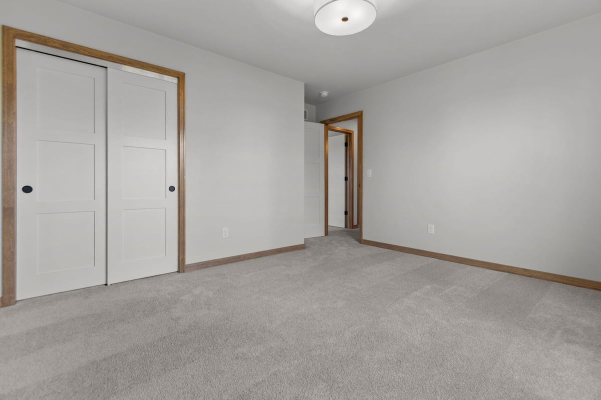 Modern bedroom with neutral tones by Midwest Design Homes in Appleton WI and Green Bay WI