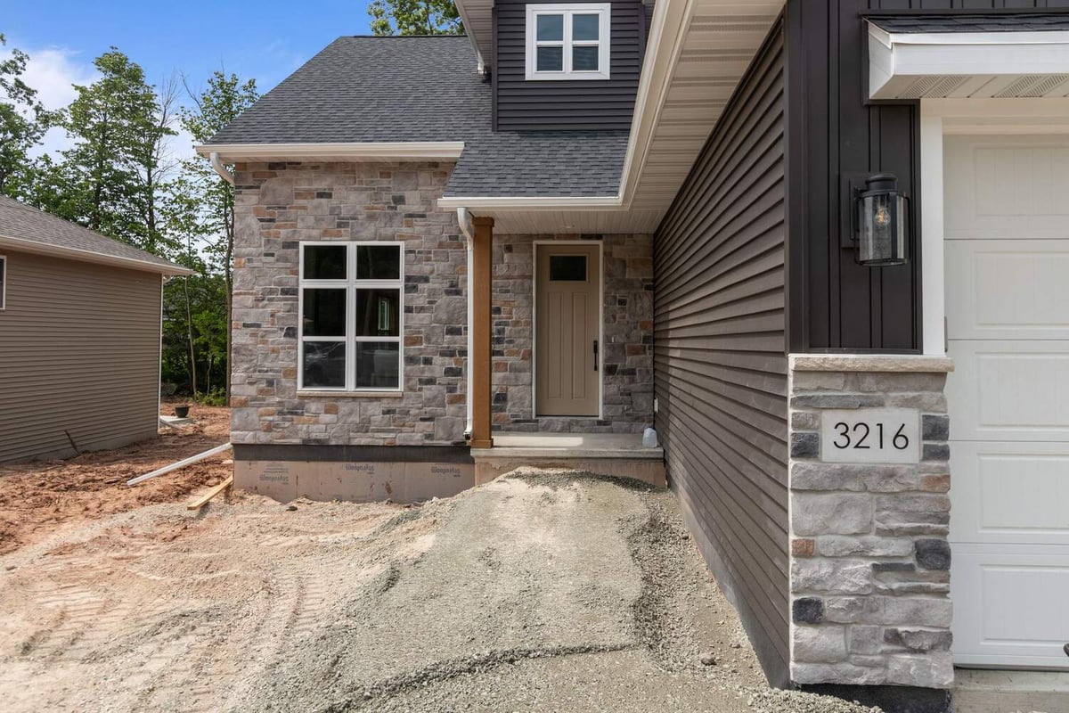 Stone and siding entryway of custom home in De Pere, WI by Midwest Design Homes