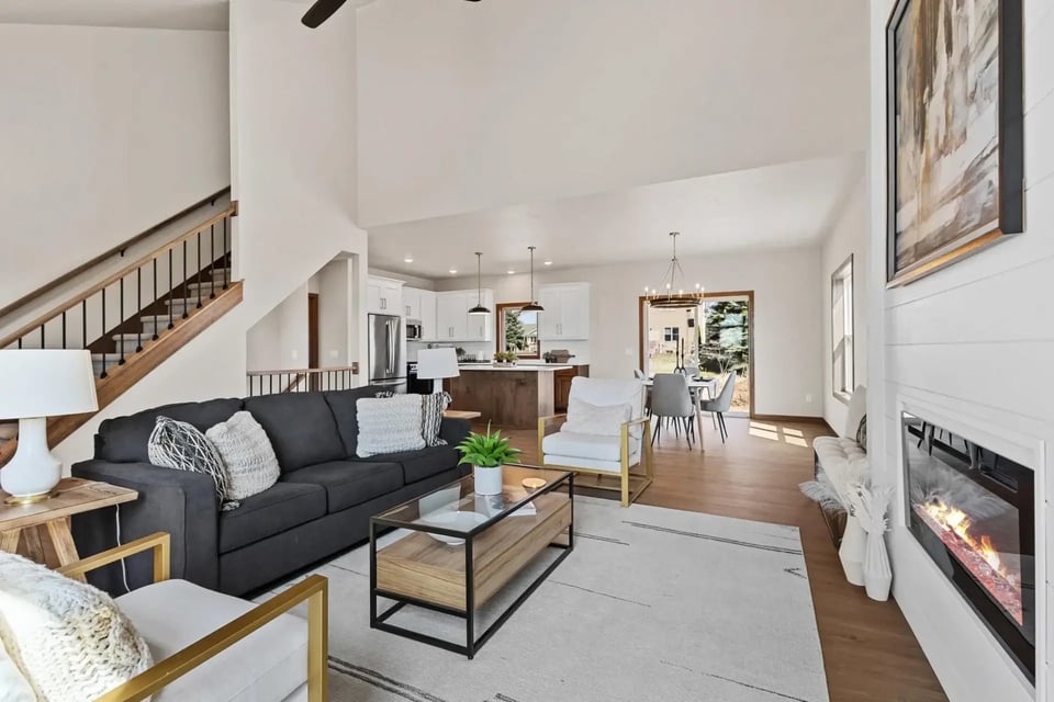 Bright living room with modern decor, open layout, and fireplace in a Fox Cities home