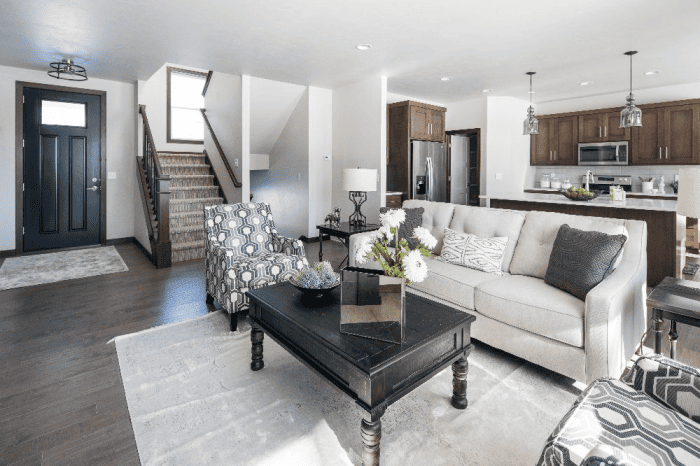 Open-concept living room and kitchen with dark wood floors and neutral furnishings in Northeast Wisconsin