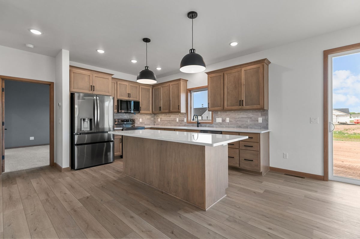 Bright kitchen with large island, wood cabinetry, and stainless appliances in Appleton, WI
