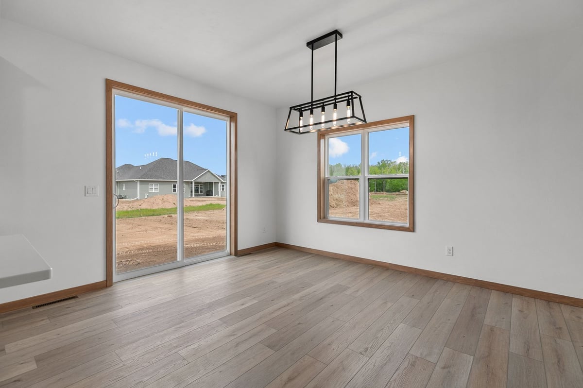 Dining area with modern lighting and backyard access in Appleton, WI