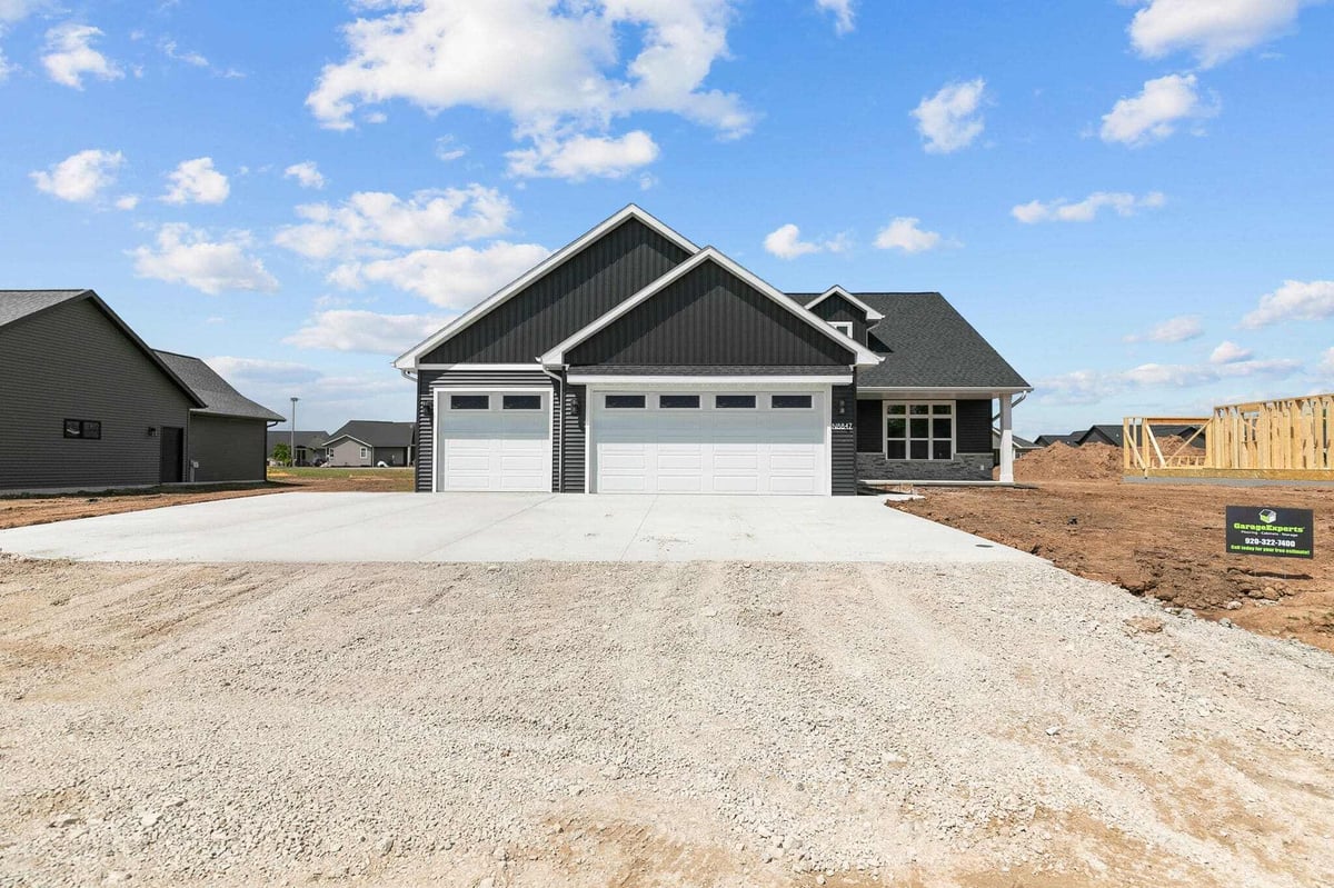 Front exterior of modern black home with three-car garage in a new Appleton, WI subdivision