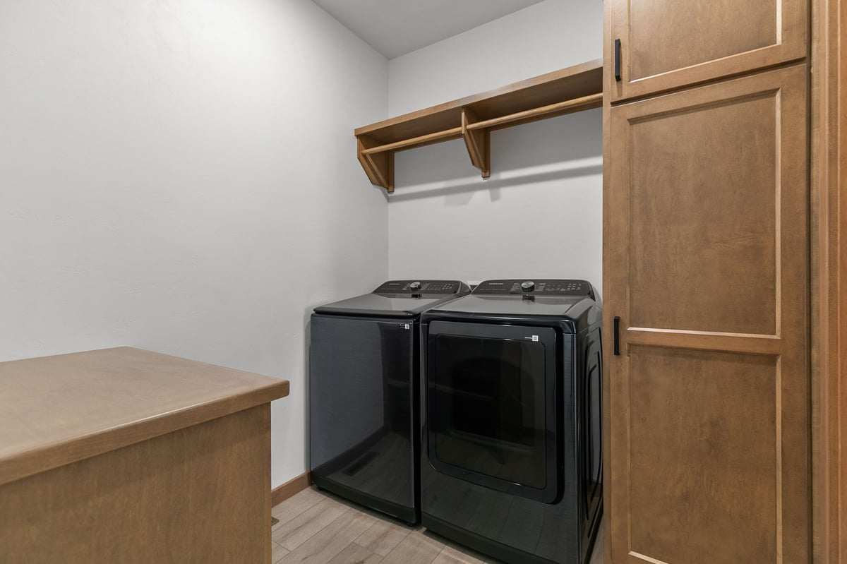 Laundry room with storage cabinets and Samsung washer and dryer in Appleton, WI