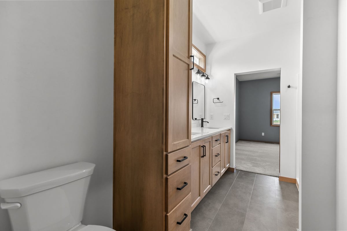 Primary bathroom with dual vanity and modern finishes in Appleton, WI