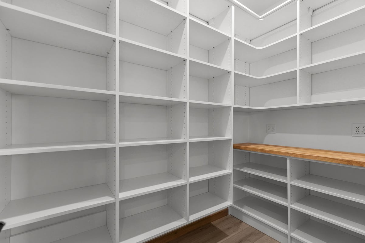 Walk-in pantry with custom shelving and prep counter in Appleton, WI