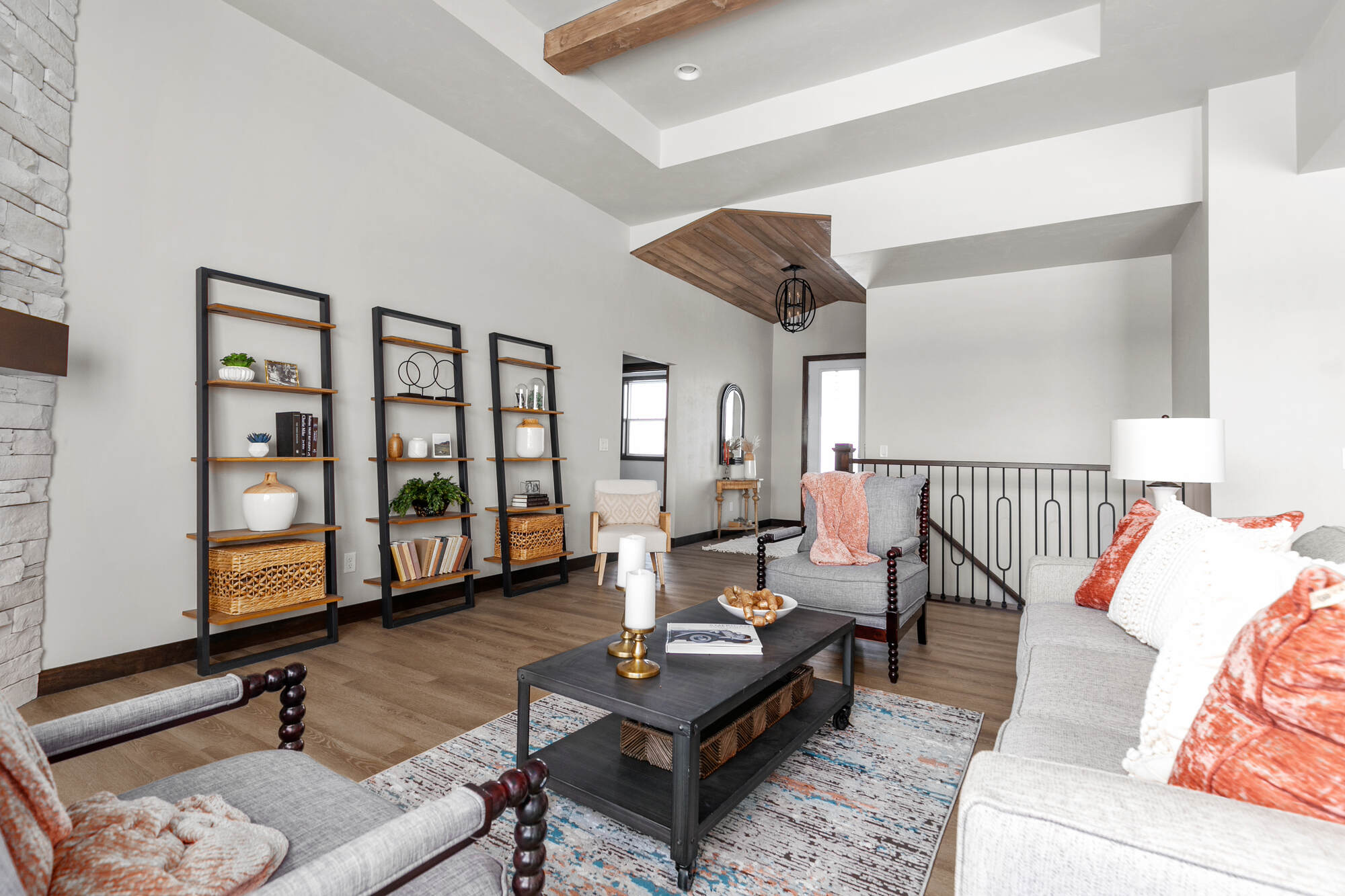White stone fireplace in bright living room by Midwest Design Homes in Fremont, WI