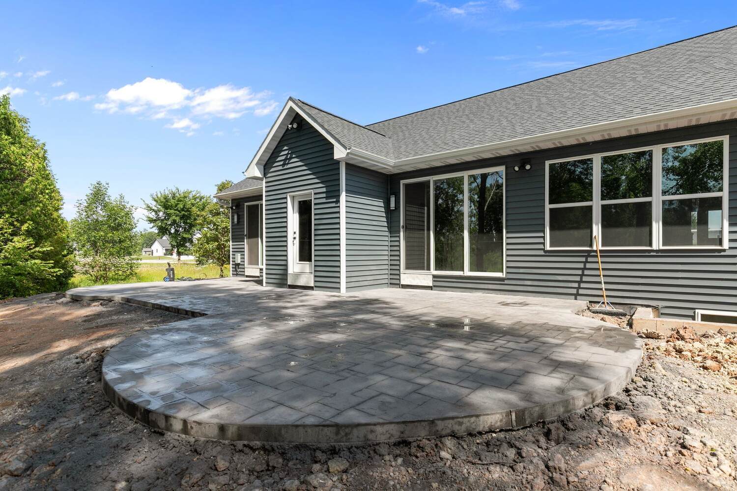 Curved stamped patio at rear of Wisconsin custom home by Midwest Design Homes Curved stamped patio at rear of Wisconsin custom home by Midwest Design Homes