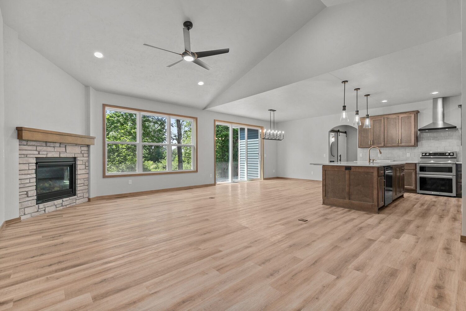 Kitchen with island and fireplace view in Greenville custom home by Midwest Design Homes Kitchen with island and fireplace view in Greenville custom home by Midwest Design Homes