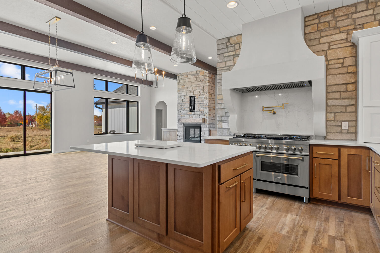 Custom kitchen with island and stone fireplace by Midwest Design Homes in Neenah WI
