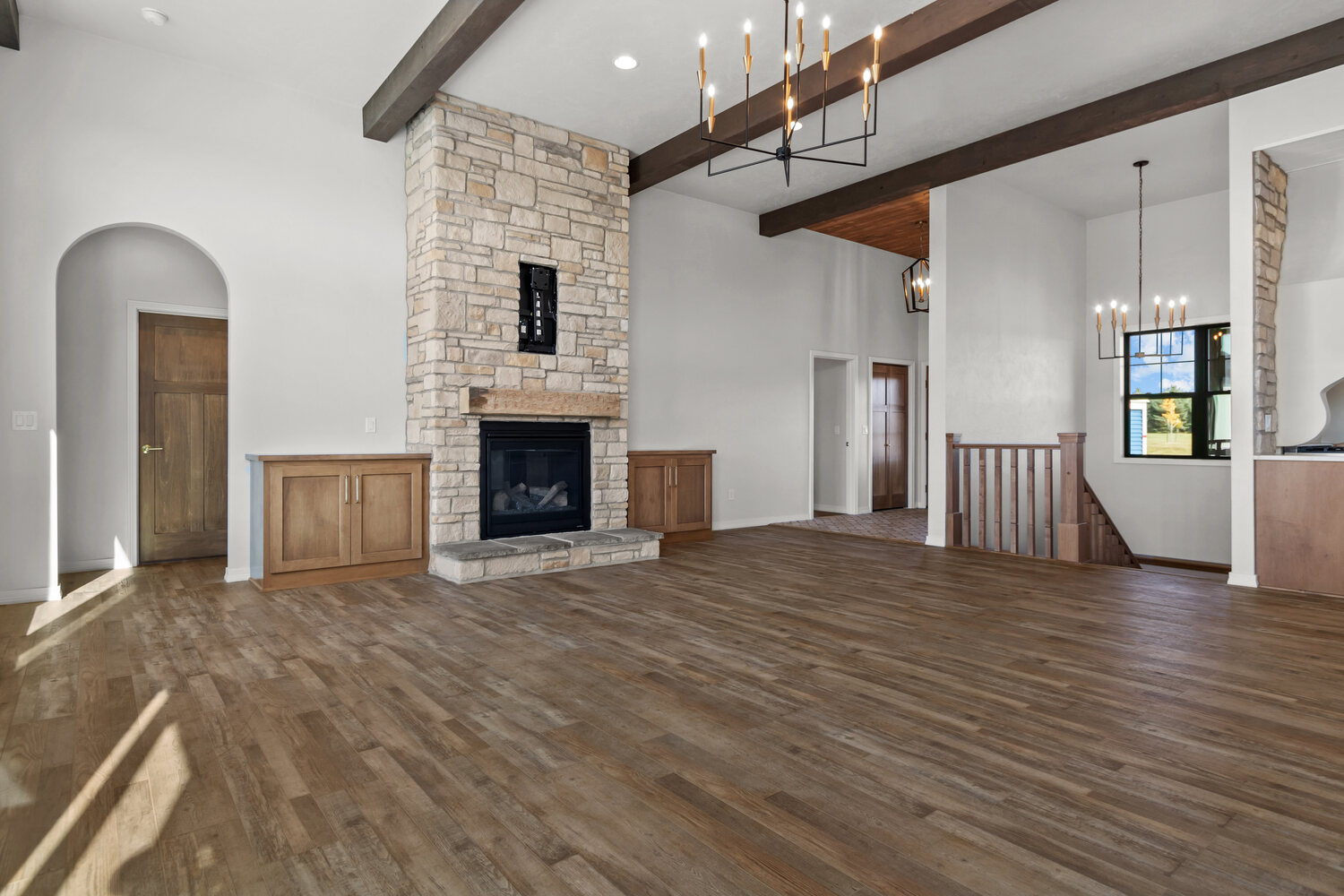 Stone fireplace in open living room by Midwest Design Homes in Lawrence, Wisconsin